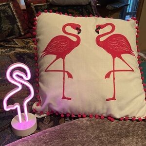 Pink flamingo pillow and neon light up flamingo.